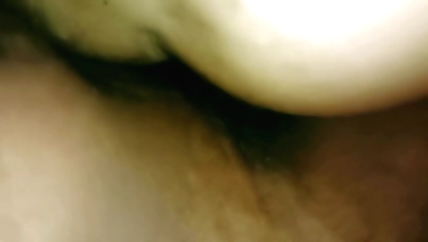 Amateur brunette in white dress fumbles around in a bedroom