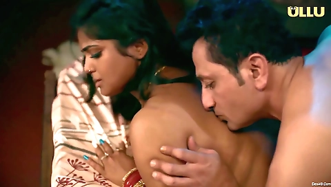 Busty brunette with a cute face and long hair in the bedroom