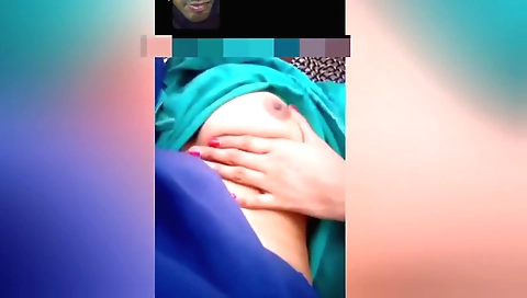 Solo female masturbates and enjoys her phone in front of window