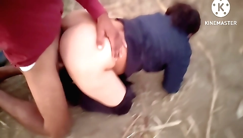 Brunette girl plays with a football outdoor in the jungle