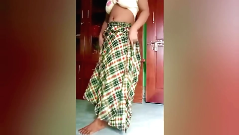 Sexy indian girl in a sexy dress dances on the chair
