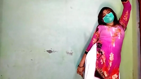 Brunette dancer in a black dress is dancing on a mat